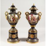 A SUPERB PAIR OF VIENNA VASES, COVERS AND STANDS, the rich blue ground edged in gilt and painted