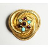 A VICTORIAN GOLD BROOCH set with opal and amethyst.