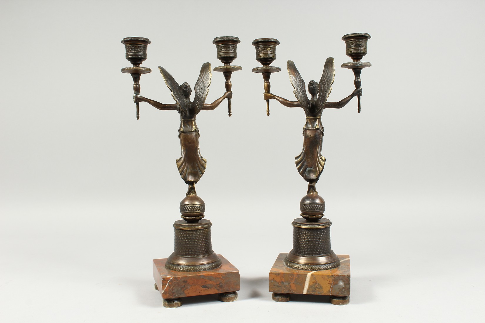 A PAIR OF EMPIRE BRONZE WINGED LADIES TWO LIGHT CANDLESTICKS on a square base. 13ins high - Image 2 of 2
