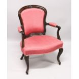 A GEORGE III SHAPED BACK ARM CHAIR with padded back, arms and seat on turned fluted legs.