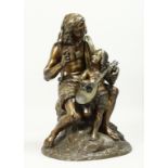 A GOOD 19TH CENTURY BRONZE GROUP a man teaching a young boy to play a mandolin. 16ins high.