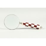 A MAGNIFYING GLASS WITH CHEQUERED HANDLE