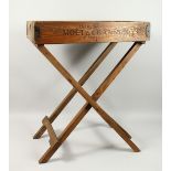 A PINE TRAY WITH FOLDING STAND, 'MOET CHANDON' TRAY. 2ft 1.5ins long