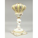 A MEISSEN PORCELAIN LAMP BASE painted and sprigged with flowers on a square base. Cross swords