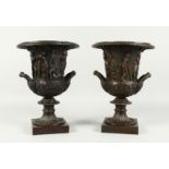 A GOOD PAIR OF CLASSICAL TWO HANDLED CAMPAGNAS URNS on square bases. 12ins high