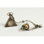 A BRASS MASONIC WATCH AND SKULL on a chain