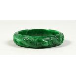 A CARVED JADE BANGEL.