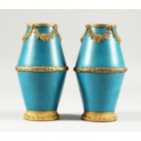 A SMALL PAIR OF SEVRES BLUE GROUND VASES with gilt garlands Mark in blue S 5 ins high