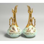A GOOD PAIR OF M. REDON, LIMOGES, TALL BULBOUS JUGS, gilt and scroll decoration with flowers.