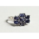 A SILVER AND SEVEN STONE SAPPHIRE RING