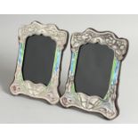 A PAIR OF ART NOUVEAU STYLE SILVER AND ENAMEL PHOTOGRAPH FRAMES with butterflies 3ins x 4.5ins