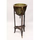 A MAHOGANY JARDINIERE with brass bowl and double column support with under tier 2ft 9ins high.