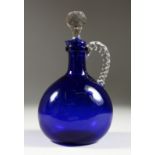 A BRISTOL BLUE CLARET JUG AND STOPPER. 8.5ins high.