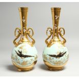A GOOD PAIR OF M. REDON, LIMOGES TWO HANDLED GILT VASES, duck-egg-blue ground painted with