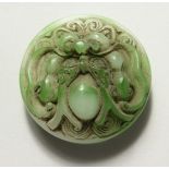 A CHINESE CIRCULAR CARVE JADE BELT BUCKLE. 2.25ins diameter.