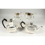 A VICTORIAN SILVER FOUR PIECE TEA SET with gadrooned edge, comprising tea pot, hot water jug , sugar
