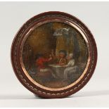 A 19TH CENTURY TORTOISESHELL CIRCULAR BOX, the lid painted with a tavern scene. 3ins diameter.