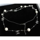 A SILVER CHANEL STYLE PEARL NECKLACE.