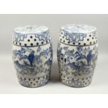 A PAIR OF CHINESE BLUE AND WHITE GARDEN SEATS decorated with parrots. 17ins high.