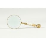 A MAGNIFYING GLASS WITH MOTHER OF PEARL AND GILT HANDLE