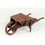 A CHILD'S WOODEN, ANTIQUE BARROW. 29ins long
