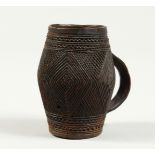 A CARVED WOOD CUP 3ins high.