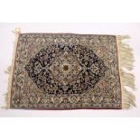 A GOOD, SMALL PERSIAN RUG, dark blue ground with stylised design 3ft 5ins x 2ft 6ins