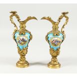 A GOOD PAIR OF SILVER GILT BRONZE AND PORCELAIN EWERS with a blue ground and vignettes of figures