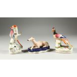 TWO STAFFORDSHIRE FLOWER ENCRUSTED BIRD PEN HOLDERS 5.5 & 6 ins high and a greyhound 5ins long (3).