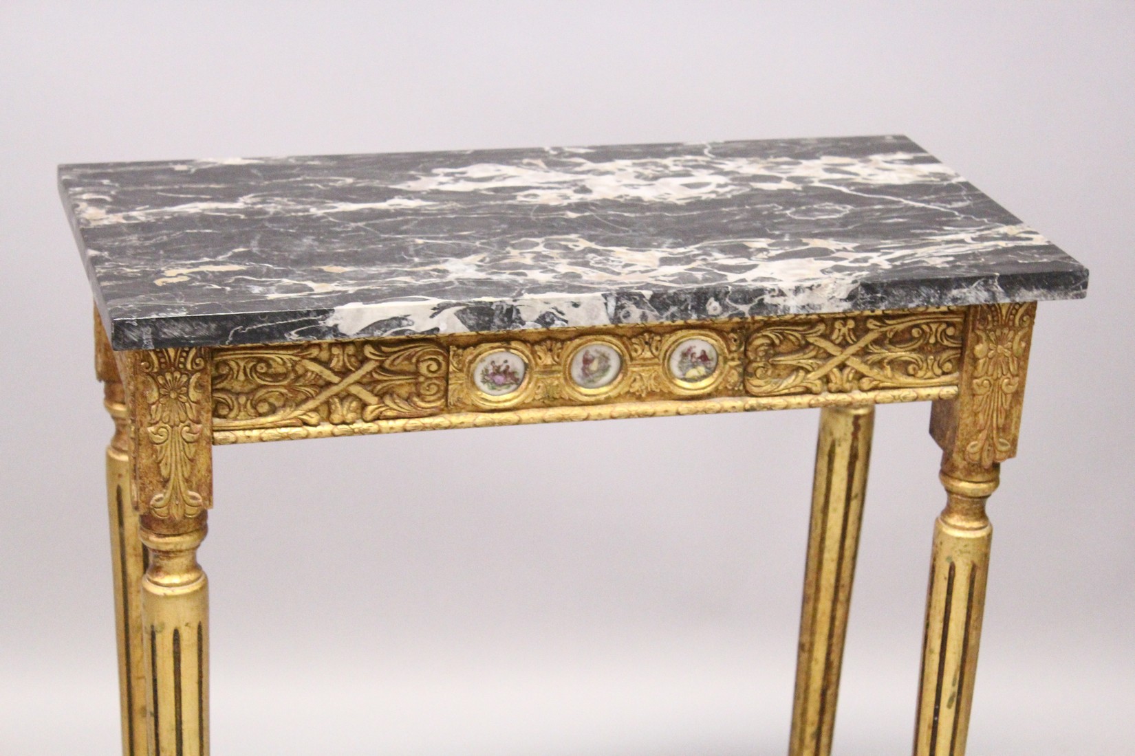 A SMALL GILDED SIDE TABLE, with marble top porcelain panels on turned tapering legs. 2ft long - Image 2 of 7