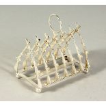 A SILVER PLATE TOAST RACK, CROSS RIFLES