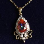 A 9CT GOLD TOPAZ AND DIAMOND PENDANT AND CHAIN