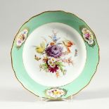 A MEISSEN PORCELAIN PLATE, with green border and vignettes of flowers. The white centre painted with