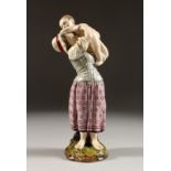 A GOOD HOCHST POTTERY FIGURE OF A MOTHER AND CHILD. Hochst Mark No. 157. 9ins high.