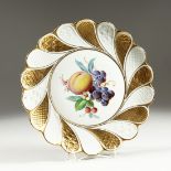 A GOOD MEISSEN SWIRLING GILDED PLATE, the centre painted with fruit. Cross swords mark in blue,