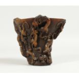 A CHINESE CARVED HORN LIBATION CUP. 5ins high.