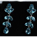 A PAIR OF SILVER AND TOPAZ DROP EAR RINGS