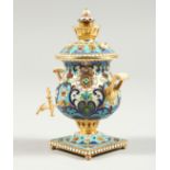 A GOOD SMALL RUSSIAN SILVER GILT AND CHAMPLEVE ENAMEL MINIATURE SAMOVAR, stamped 84 4ins high.