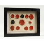 A COLLECTION OF TWELVE OLD WAX SEALS framed and glaze. 9.5ins x 7.5inS.