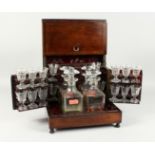 A 19th CENTURY ROSEWOOD DRINKS BOX with brass lines opening to reveal four decanters and stoppers