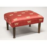 A SMALL FOOTSTOOL UPHOLSTERED with a dragonfly material 1ft 6ins long x 11ins high.