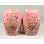 A PAIR OF CHINESE PINK GARDEN SEATS decorated with butterflies and flowers 18ins high.