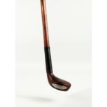 A SMALL WALKING STICK, the handle as a golf club. 32ins long.