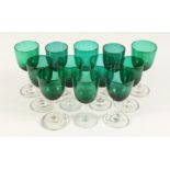 TWELVE MIXED VICTORIAN GREEN TINTED WINE GLASSES