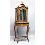 A GOOD LOUIS XVI STYLE SERPENTINE FRONTED STANDING DISPLAY CABINET, with rich ormolu mounts, the