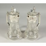 A GOOD PAIR OF ETCHED GLASS CLARET JUGS with plated mounts