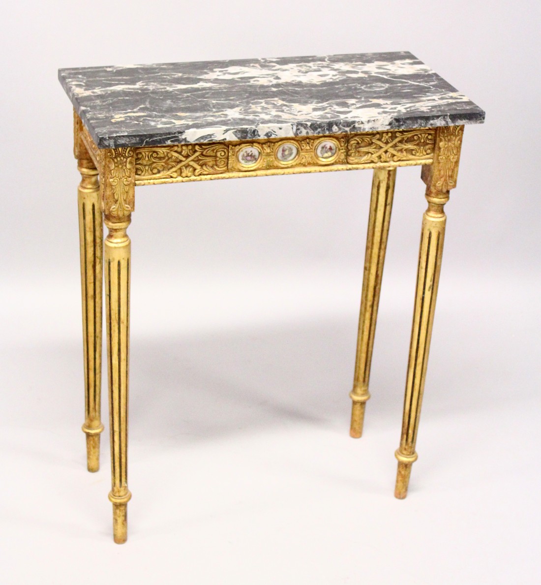 A SMALL GILDED SIDE TABLE, with marble top porcelain panels on turned tapering legs. 2ft long