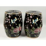 A PAIR OF CHINESE FAMILLE NOIR GARDEN SEATS decorated with birds and roses 18ins high.