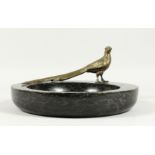 A LARGE MARBLE BOWL with a cast model of a long tailed pheasant. 12ins diameter.