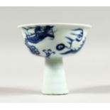 A CHINESE BLUE AND WHITE STEM CUP decorated with dragons 3.75ins diameter.